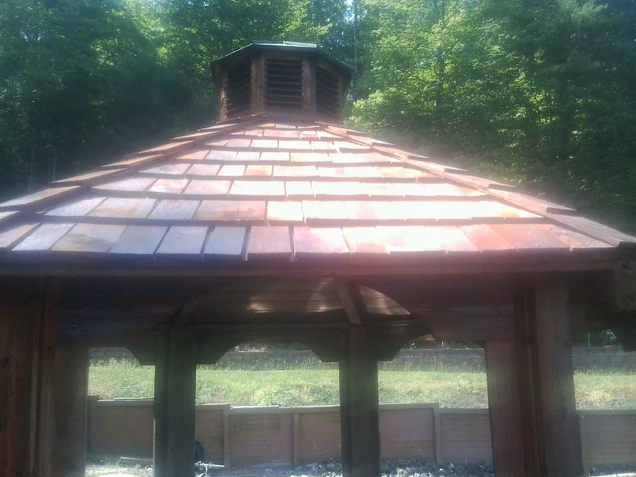New cedar shake roof and cupola on a lakeside gazebo in Westport